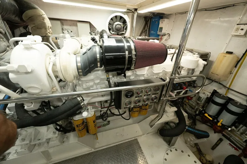Ok'd By Dad Yacht Photos Pics Engine room of a 2001 Mikelson 61 Yachtfisher, showcasing detailed mechanical components.
