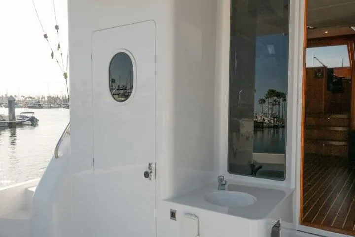Ok'd By Dad Yacht Photos Pics 2001 Mikelson 61 Yachtfisher exterior with sink and door, docked at marina.