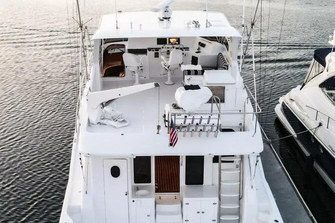 Ok'd By Dad Yacht Photos Pics 2001 Mikelson 61 Yachtfisher, aerial view, docked, showcasing spacious deck and seating area.