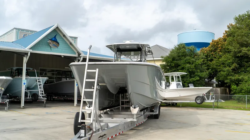  Yacht Photos Pics 2021 Invincible 37 Catamaran on trailer outside dealership.
