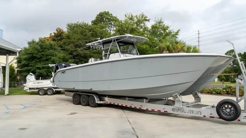  Yacht Photos Pics 2021 Invincible 37 Catamaran on trailer, parked outdoors.