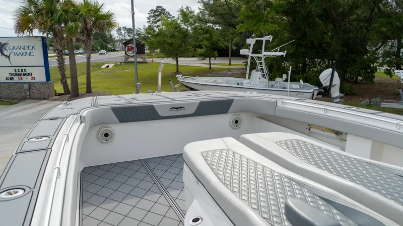  Yacht Photos Pics 2021 Invincible 37 Catamaran at marina, showcasing spacious deck and seating.