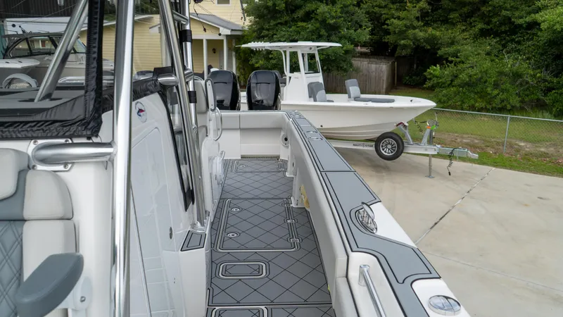  Yacht Photos Pics 2021 Invincible 37 Catamaran with sleek deck design and modern features, parked outdoors.