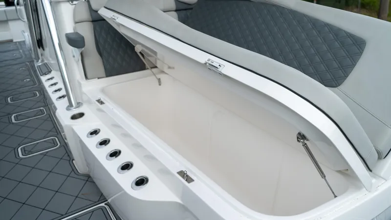  Yacht Photos Pics Invincible 37 Catamaran 2021 open storage compartment with cushioned seating and rod holders.