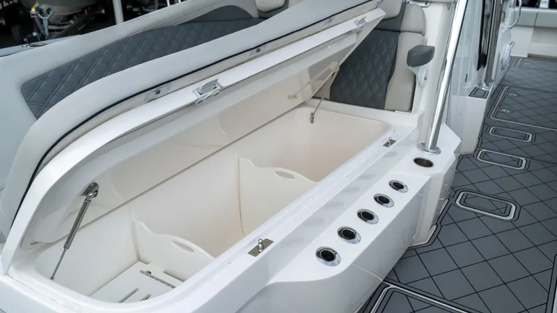  Yacht Photos Pics Open storage compartment on 2021 Invincible 37 Catamaran with rod holders and cushioned seating.