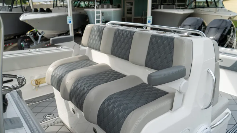  Yacht Photos Pics 2021 Invincible 37 Catamaran interior with quilted seating in a showroom.