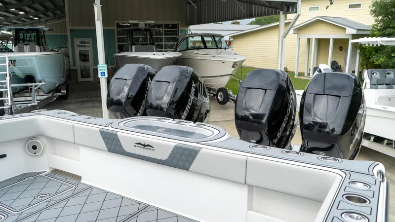  Yacht Photos Pics 2021 Invincible 37 Catamaran with four powerful outboard engines in a boatyard.