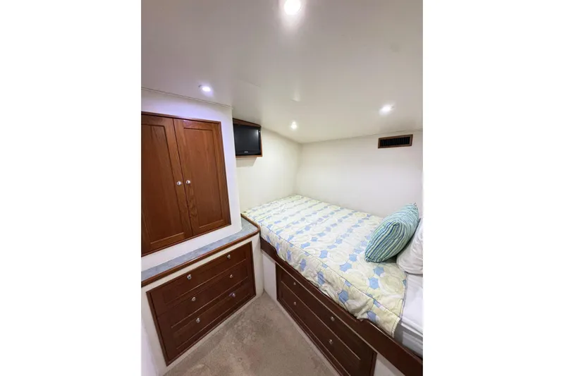 Sea Hag Yacht Photos Pics Cozy cabin interior of 2008 Blackwell Custom Carolina 61, featuring bed and wooden storage.