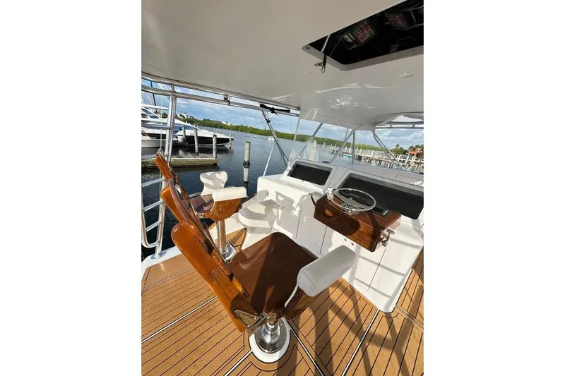 Sea Hag Yacht Photos Pics 2008 Blackwell Custom Carolina 61 yacht helm with wooden chairs and steering wheel, dockside view.