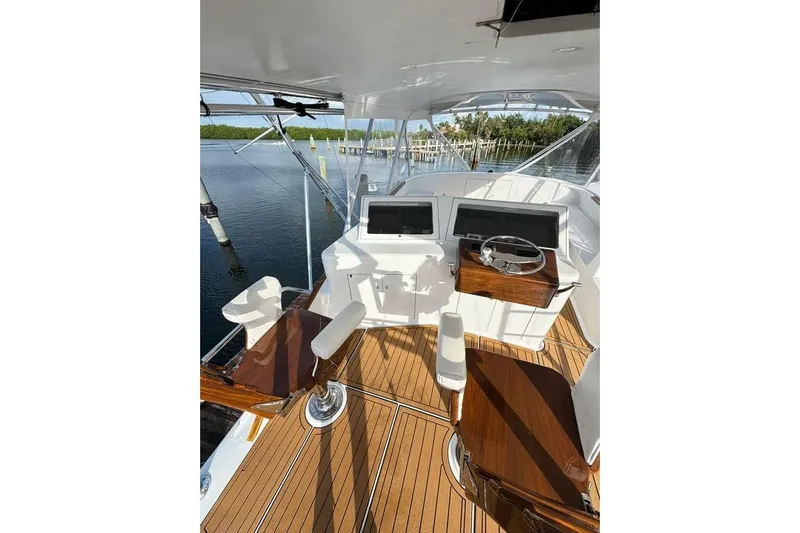 Sea Hag Yacht Photos Pics Helm of 2008 Blackwell Custom Carolina 61, featuring dual screens and wooden accents.