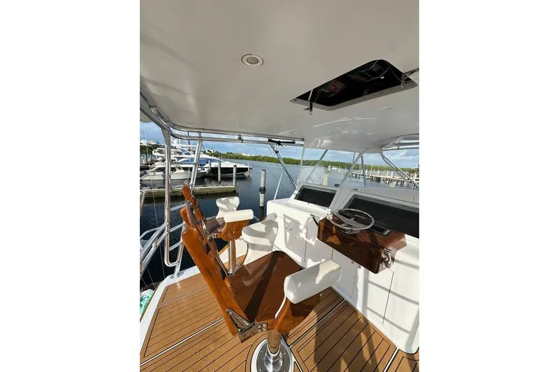 Sea Hag Yacht Photos Pics 2008 Blackwell Custom Carolina 61 yacht helm with wooden chairs and steering wheel.