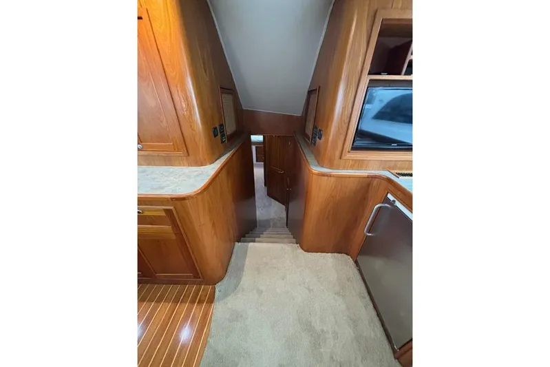Sea Hag Yacht Photos Pics Interior of 2008 Blackwell Custom Carolina 61, featuring wooden cabinetry and carpeted flooring.