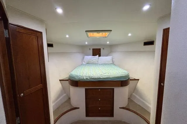 Sea Hag Yacht Photos Pics Luxurious cabin interior of 2008 Blackwell Custom Carolina 61, featuring a cozy bed and wooden accents.