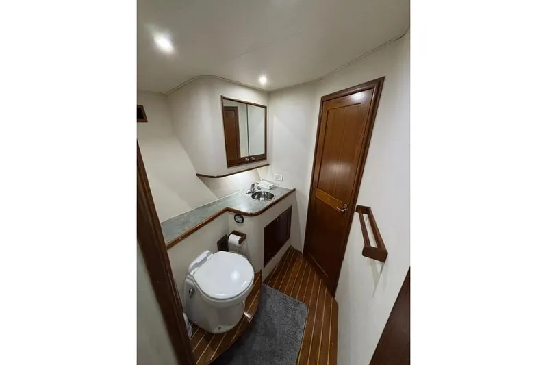 Sea Hag Yacht Photos Pics Bathroom interior of 2008 Blackwell Custom Carolina 61 yacht, featuring wood accents and modern fixtures.