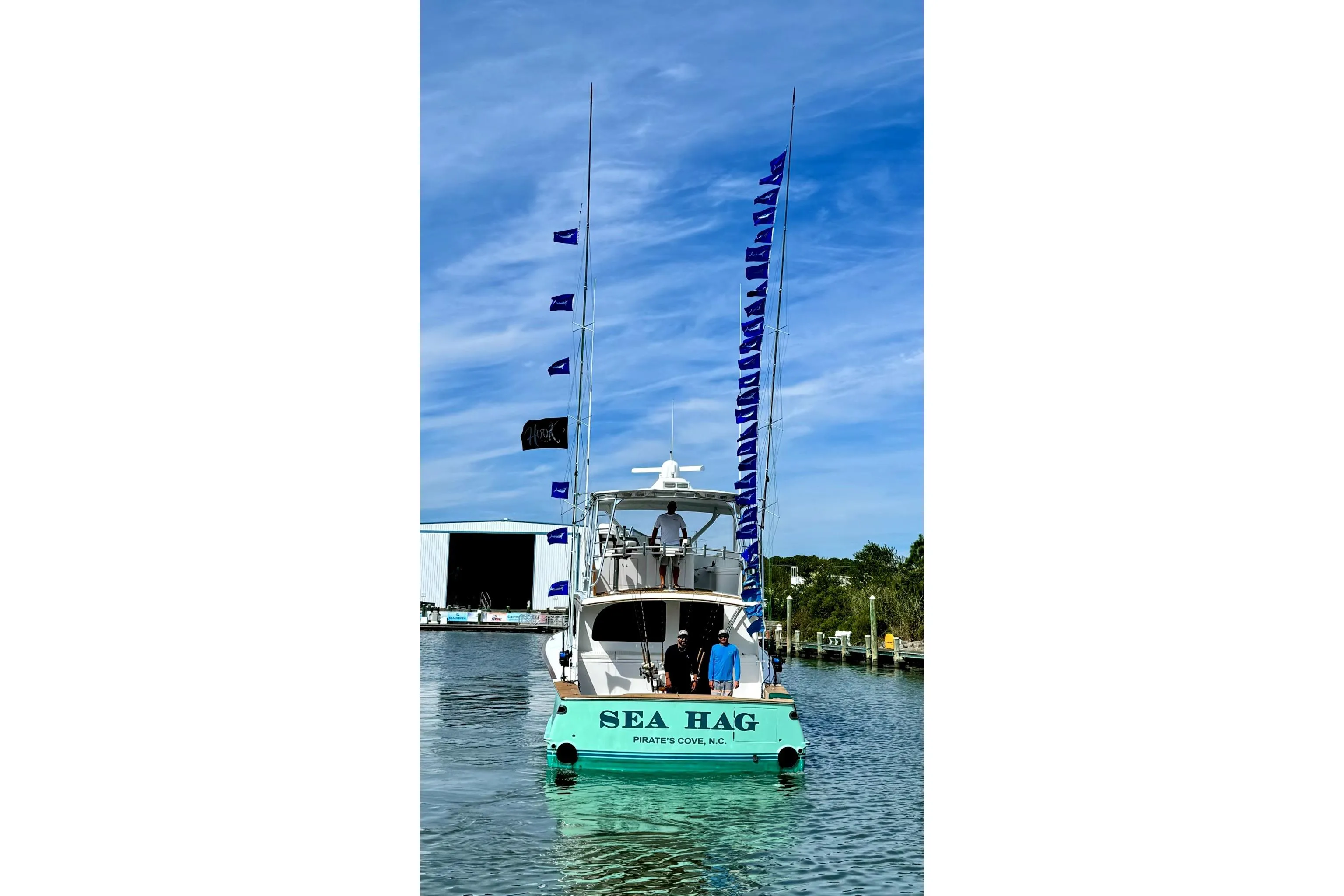2008 Blackwell Custom Carolina 61 boat with flags, docked at Pirate's Cove, NC.