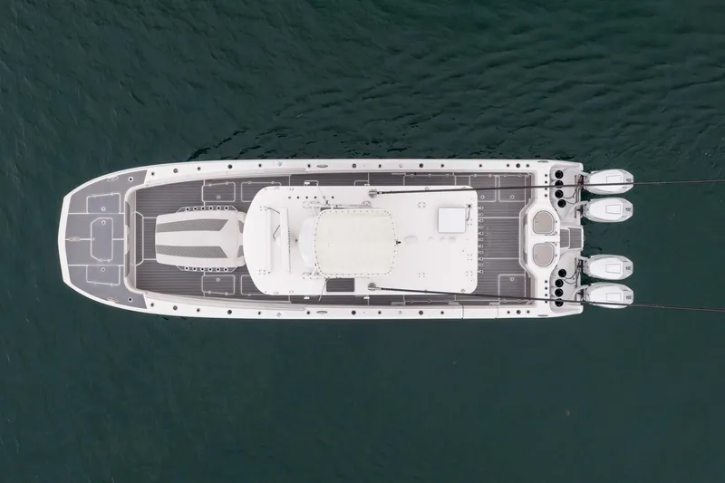  Yacht Photos Pics Overhead view of 2020 Invincible 40 Catamaran on water, showcasing sleek design and multiple engines.