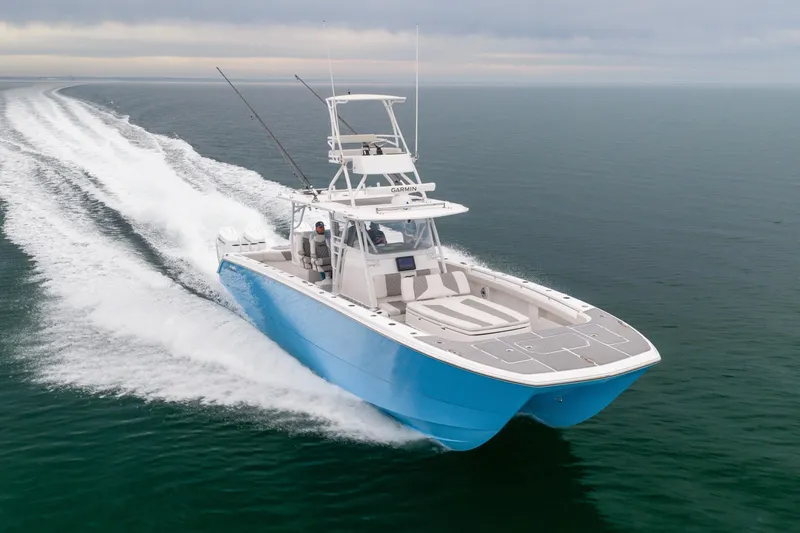  Yacht Photos Pics 2020 Invincible 40 Catamaran cruising swiftly on open water.