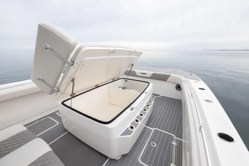  Yacht Photos Pics 2020 Invincible 40 Catamaran deck with open storage compartment, sleek design, and ocean view.