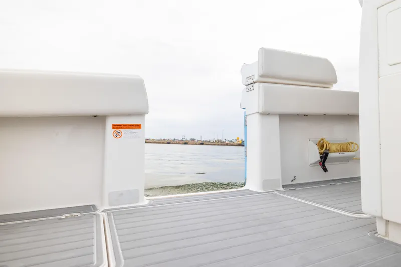  Yacht Photos Pics 2020 Invincible 40 Catamaran deck view with seating and water hose storage.