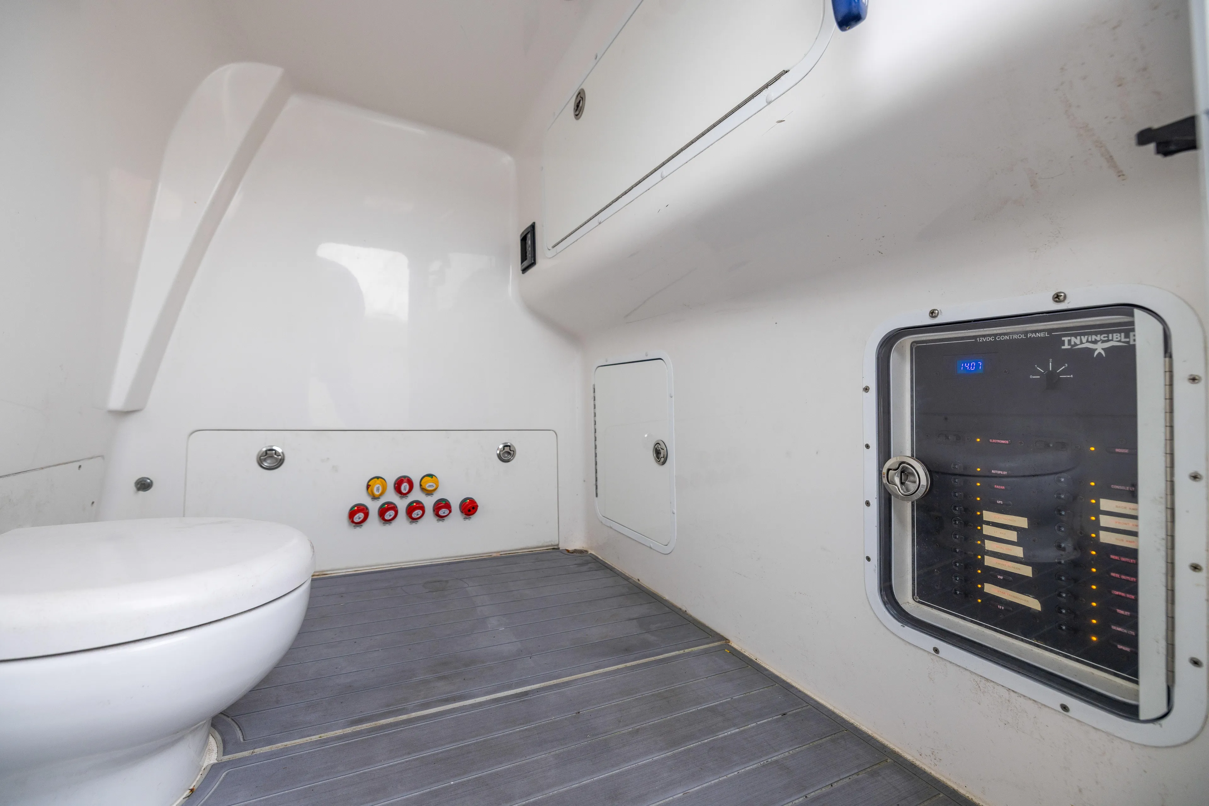  Yacht Photos Pics 2020 Invincible 40 Catamaran interior with control panel and marine toilet.