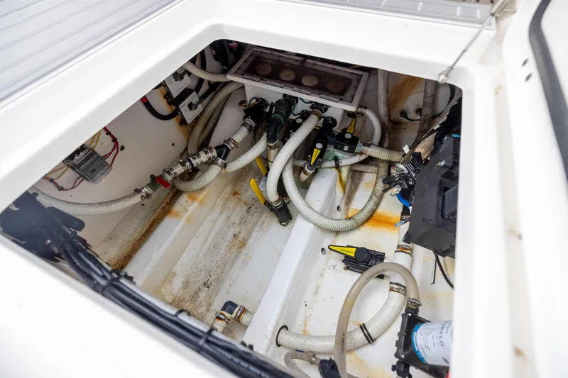  Yacht Photos Pics Engine compartment of a 2020 Invincible 40 Catamaran, showcasing hoses and mechanical components.