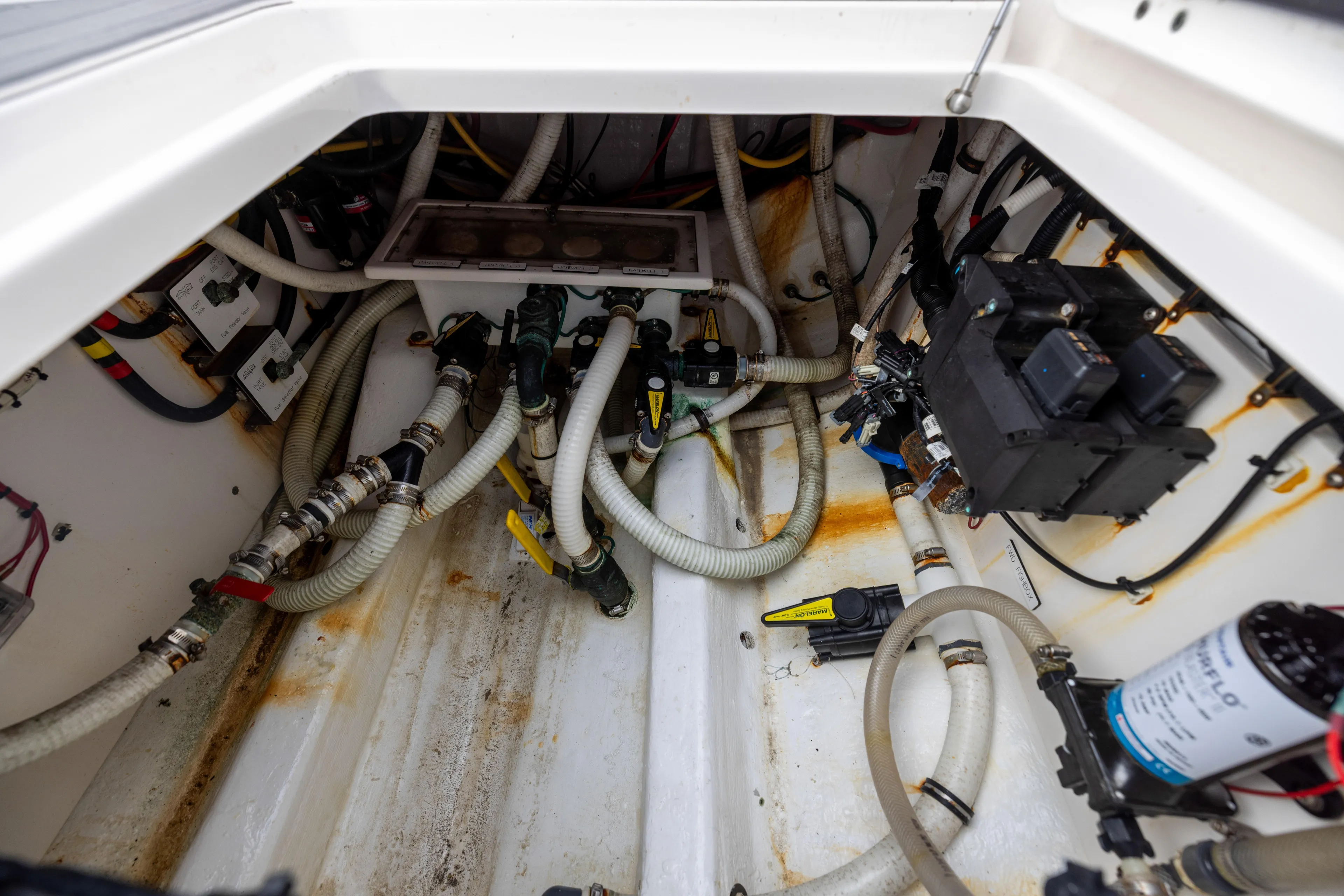 Yacht Photos Pics Engine compartment of a 2020 Invincible 40 Catamaran, showcasing hoses and electrical components.