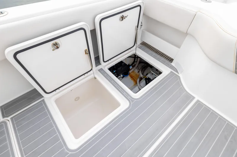  Yacht Photos Pics Open storage compartments on 2020 Invincible 40 Catamaran deck, showcasing interior space.