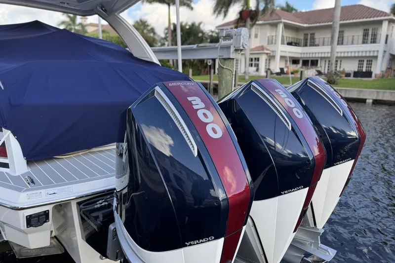  Yacht Photos Pics 2021 Formula 330 Crossover Bowrider OB with triple Mercury 300 engines docked by waterfront home.