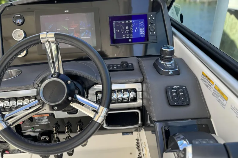  Yacht Photos Pics 2021 Formula 330 Crossover Bowrider OB dashboard with steering wheel and control panels.