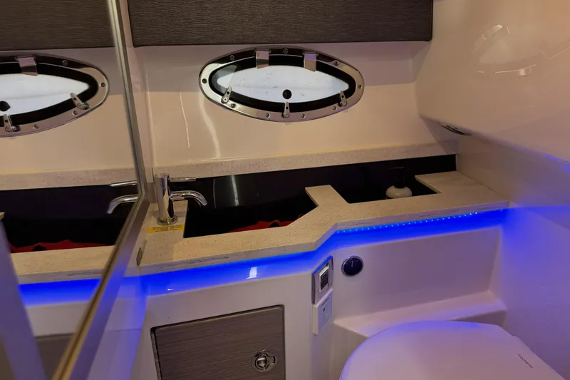  Yacht Photos Pics 2021 Formula 330 Crossover Bowrider OB bathroom with modern sink, mirror, and blue LED lighting.