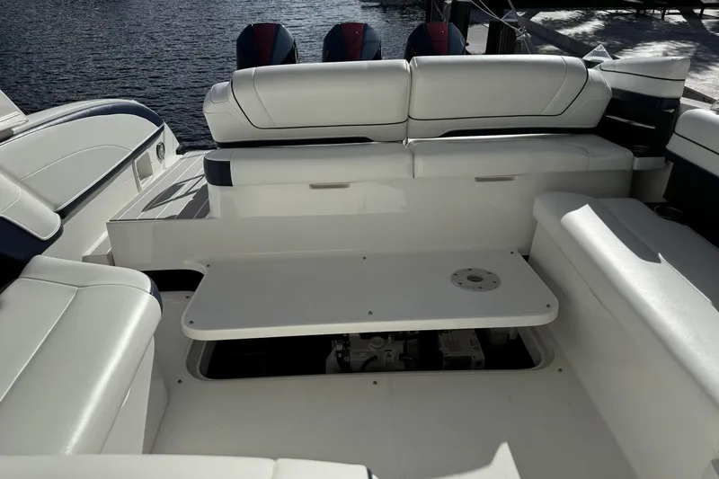  Yacht Photos Pics 2021 Formula 330 Crossover Bowrider OB interior with white seating and table.