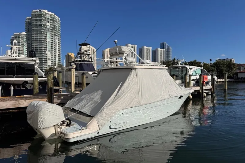  Yacht Photos Pics 2021 Robalo R317 Dual Console boat covered at marina with city skyline.