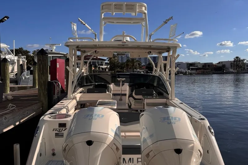  Yacht Photos Pics 2021 Robalo R317 Dual Console boat docked at marina under clear blue sky.