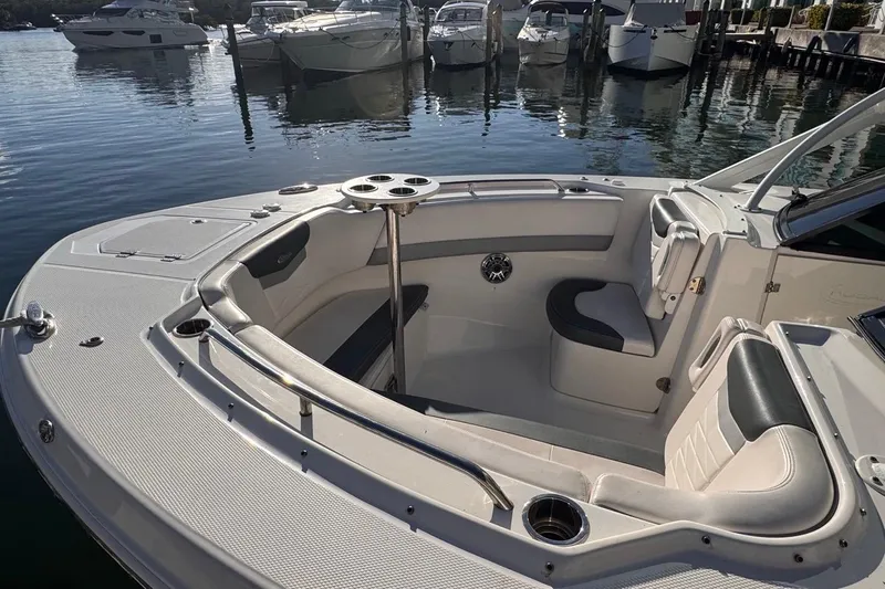  Yacht Photos Pics 2021 Robalo R317 Dual Console boat interior with seating and cup holders at marina.