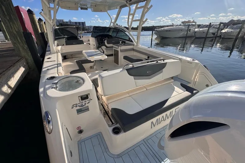  Yacht Photos Pics 2021 Robalo R317 Dual Console boat docked, featuring spacious seating and modern design.