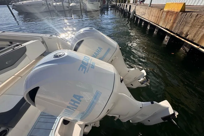  Yacht Photos Pics 2021 Robalo R317 Dual Console with twin Yamaha 300 engines docked by the water.