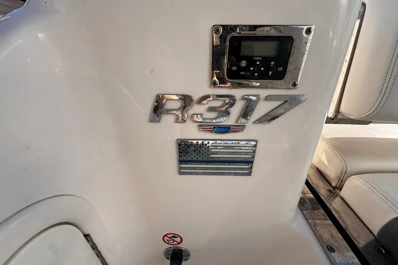  Yacht Photos Pics 2021 Robalo R317 Dual Console boat interior with control panel and emblem.