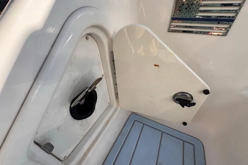  Yacht Photos Pics 2021 Robalo R317 Dual Console boat interior with storage compartment and latch.