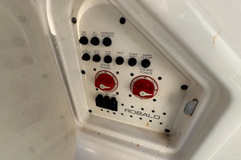  Yacht Photos Pics Control panel of 2021 Robalo R317 Dual Console boat with power switches and dials.