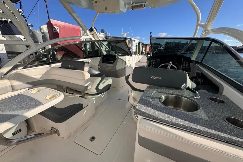  Yacht Photos Pics 2021 Robalo R317 Dual Console boat interior with seating, sink, and steering wheel.