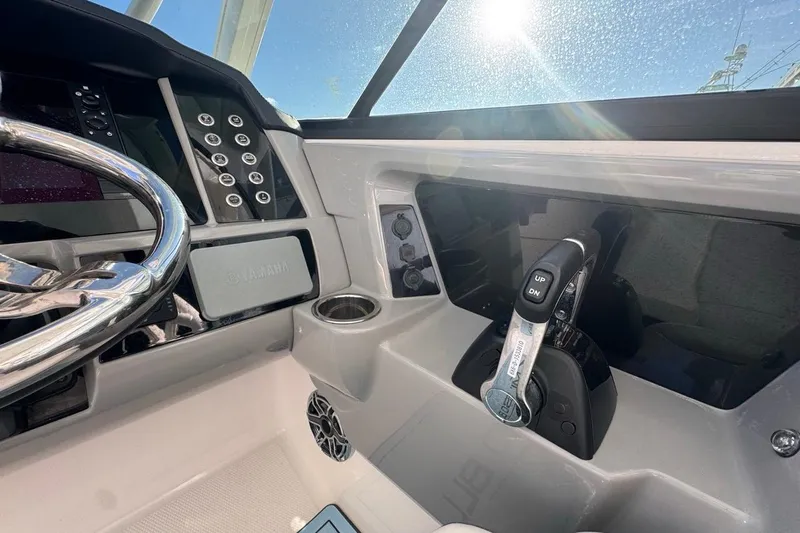  Yacht Photos Pics 2021 Robalo R317 Dual Console helm with steering wheel and controls in sunlight.