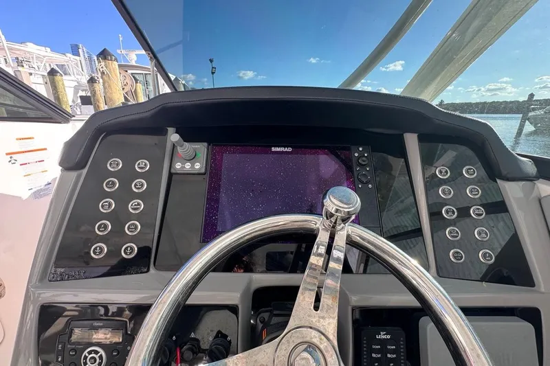  Yacht Photos Pics 2021 Robalo R317 Dual Console helm with steering wheel and navigation controls.