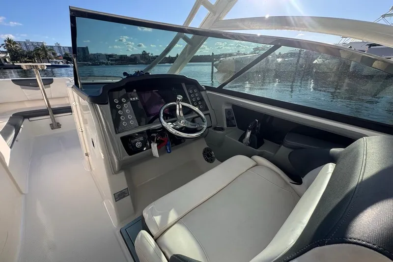  Yacht Photos Pics 2021 Robalo R317 Dual Console boat cockpit with steering wheel and control panel.