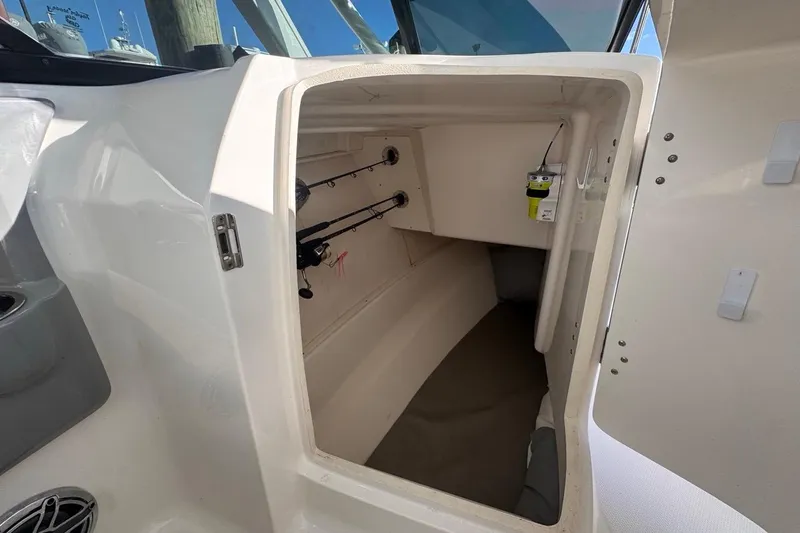  Yacht Photos Pics 2021 Robalo R317 Dual Console cabin interior with fishing rod storage.