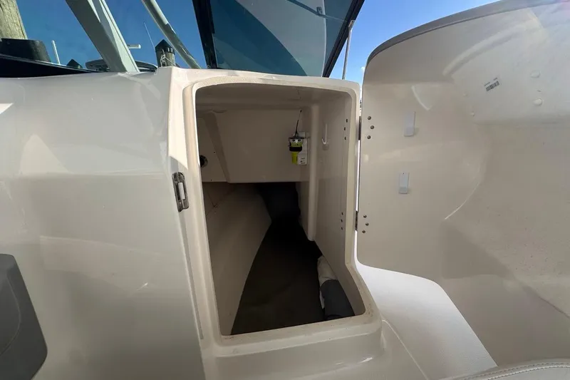  Yacht Photos Pics 2021 Robalo R317 Dual Console interior storage compartment with open door.