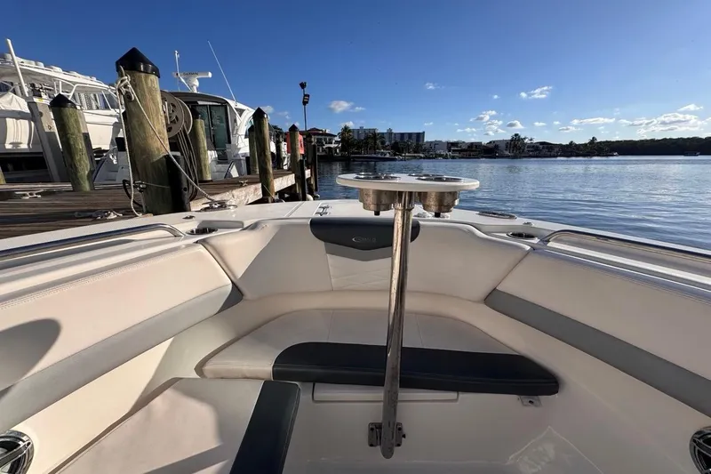  Yacht Photos Pics 2021 Robalo R317 Dual Console boat interior at marina, sunny day, calm water.