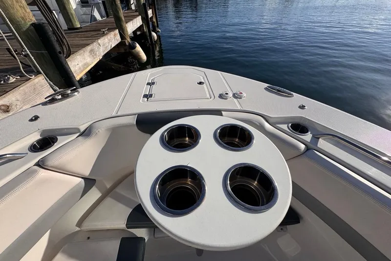 Yacht Photos Pics 2021 Robalo R317 Dual Console boat interior with cup holders, docked by the water.