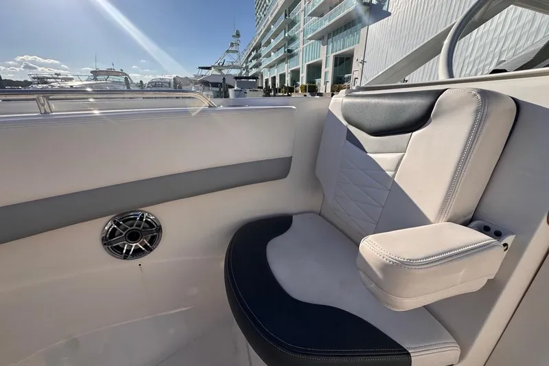  Yacht Photos Pics 2021 Robalo R317 Dual Console boat interior with cushioned seating and speaker.
