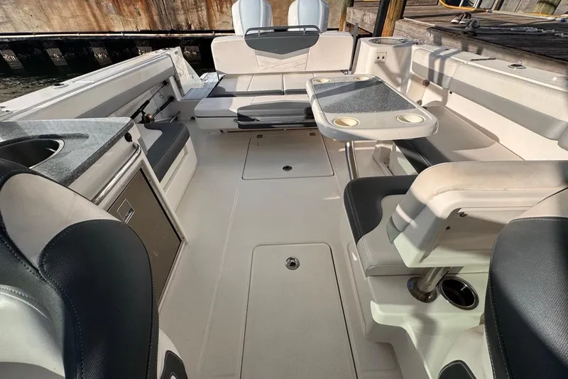  Yacht Photos Pics 2021 Robalo R317 Dual Console boat interior with seating and table setup.