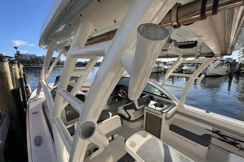  Yacht Photos Pics 2021 Robalo R317 Dual Console boat interior with seating and helm, docked by the water.